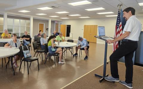 Bruce Wawrzyniak stands at the podium and speaks at the workshop Saturday