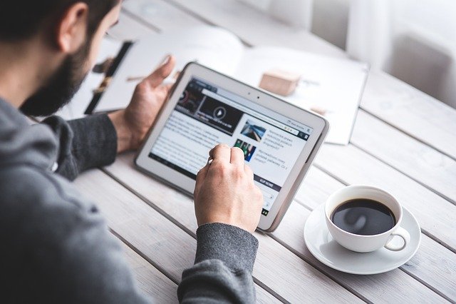 Guy reading blog on tablet