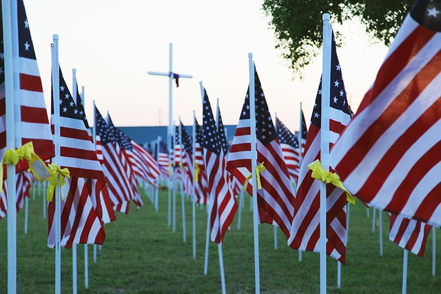 Flags in cemetary near cross