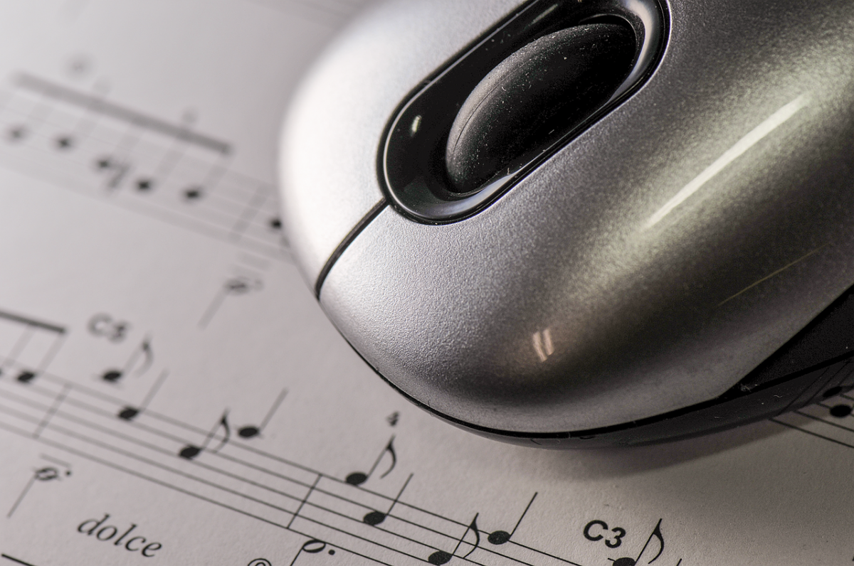 Computer mouse over sheet music