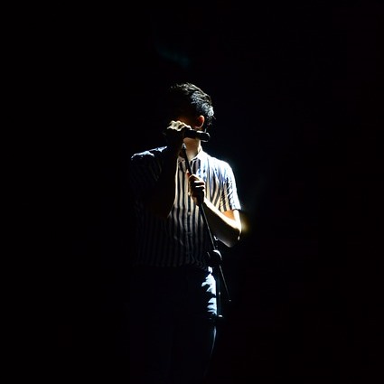 Singer on dark stage