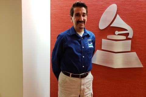 Bruce Wawrzyniak at The Recording Academy posing by the GRAMMY logo