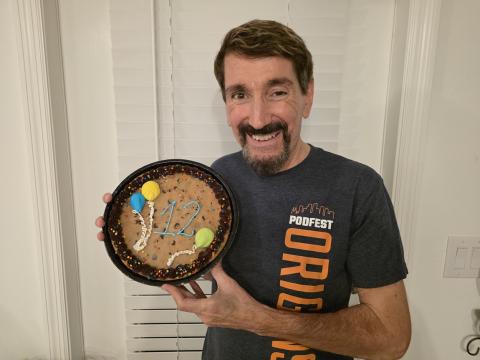 Bruce Wawrzyniak holds a cookie cake with 12 written on it