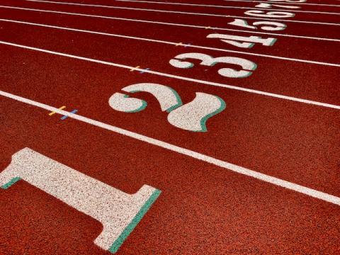 Unoccupied track and field lanes counting up from 1 to 7