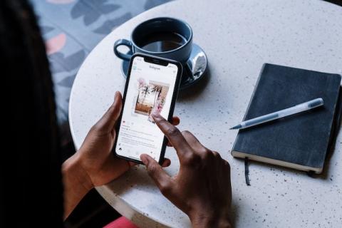 Girl's hands holding smartphone showing an Instagram post Girl's hands holding smartphone showing an Instagram post